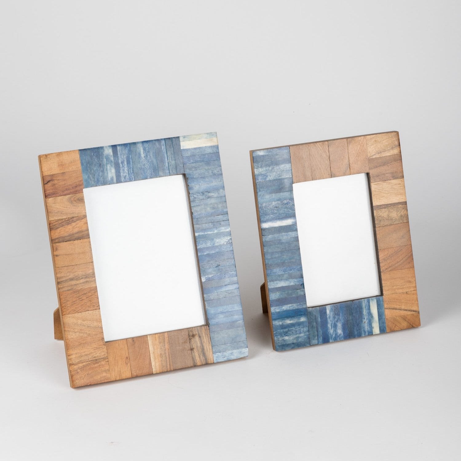 Coastal Charm Acacia Wood Picture Frame displayed on a table with family photos.