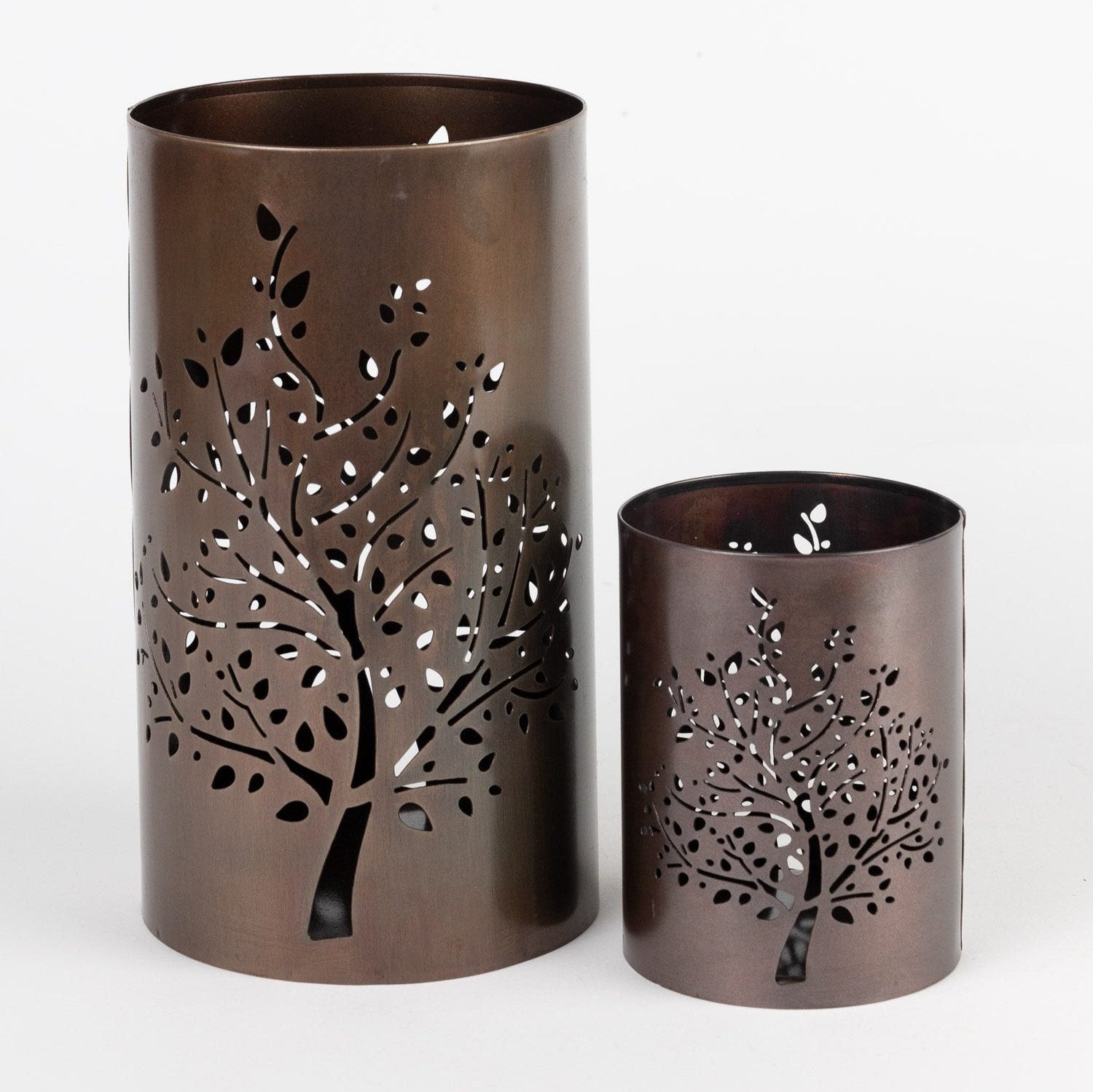 Rustic autumn tree candleholder showcasing intricate iron cutouts and warm glow.