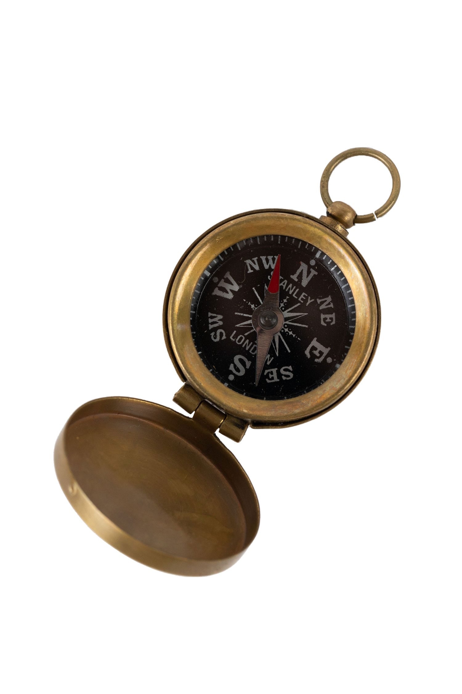 Antique brass pocket compass close-up with a hinged top, ideal for hiking.