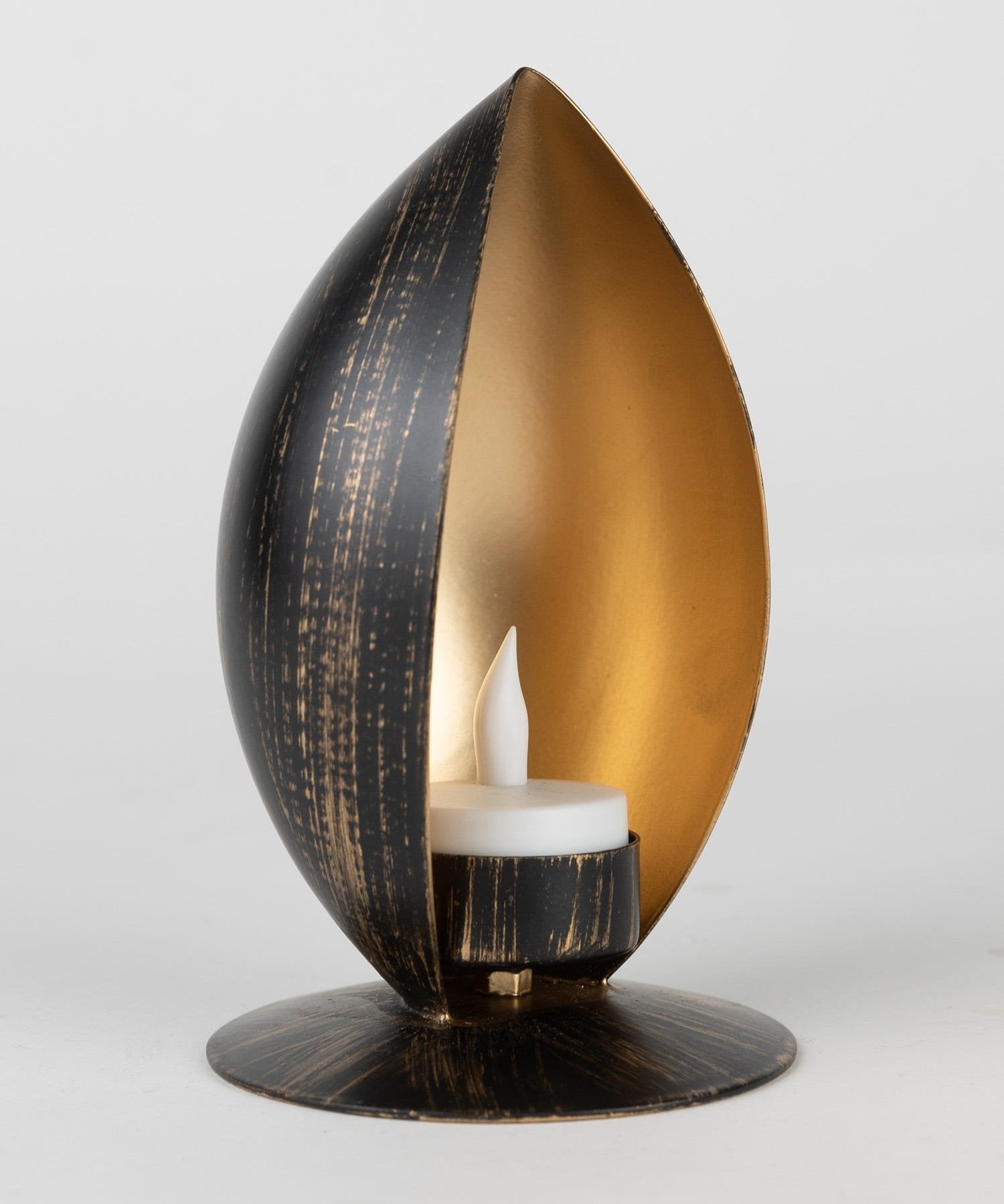 Almond Glow Artisan Candle Holder showcasing its gold matte interior and black antiqued exterior from a side angle.