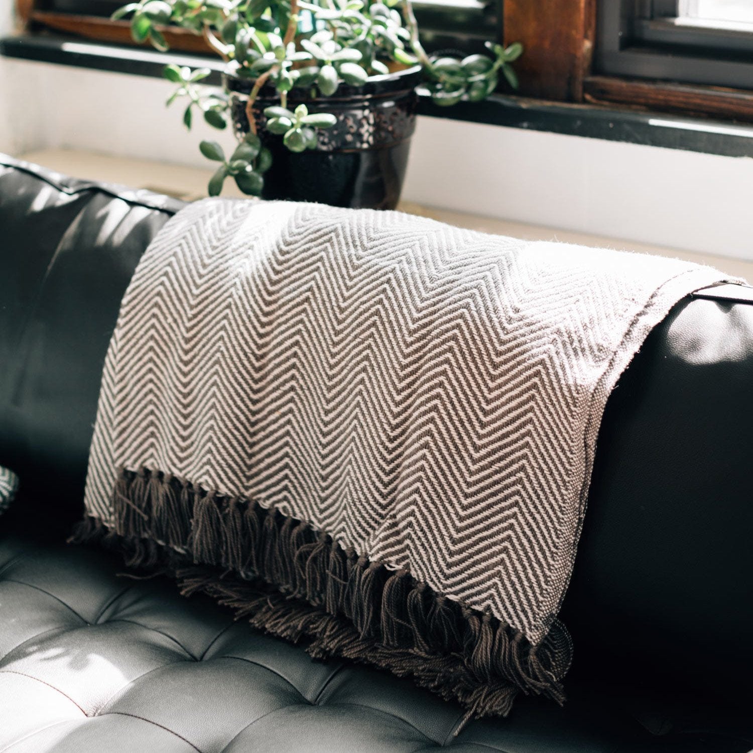 Close-up of the eco-friendly blanket woven from recycled plastic bottles, highlighting the herringbone pattern