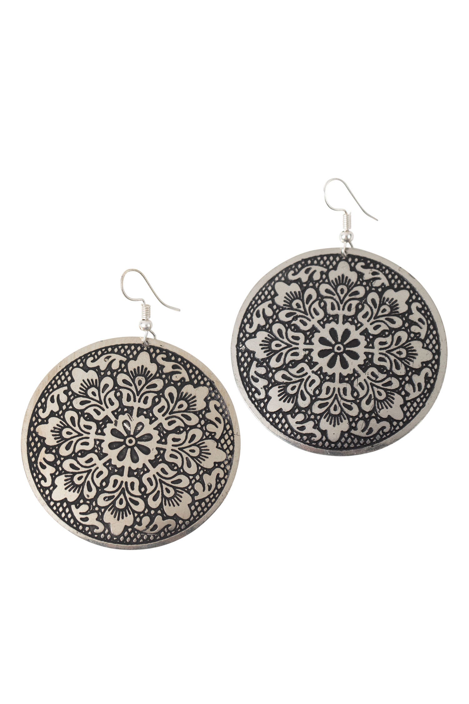A close-up of Asha's Ethnic Metal Earrings showcasing the embossed design.