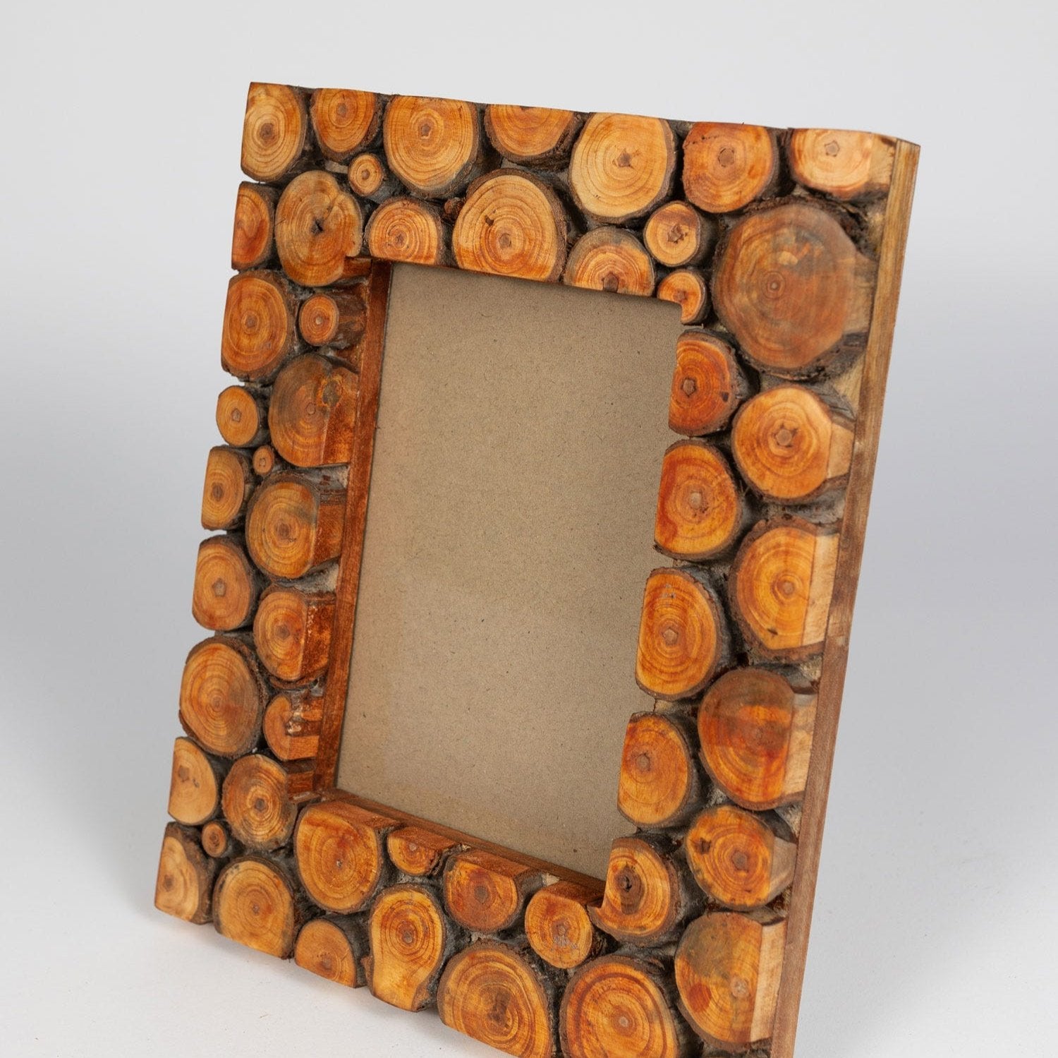 Close-up of handcrafted mango wood slice frame with natural red finish, ideal for farmhouse decor