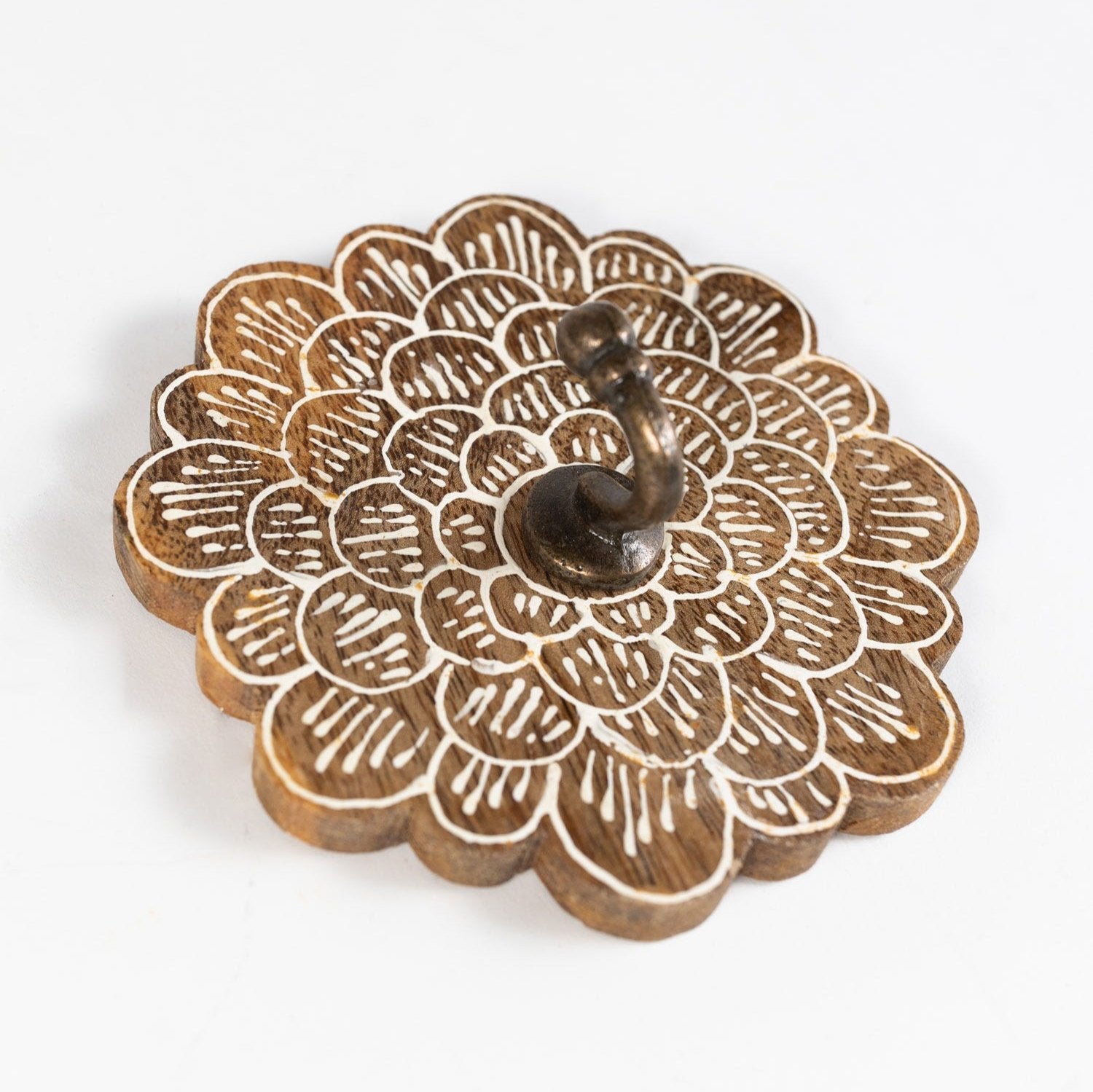 Close-up of handcrafted mango wood wall hook with floral design