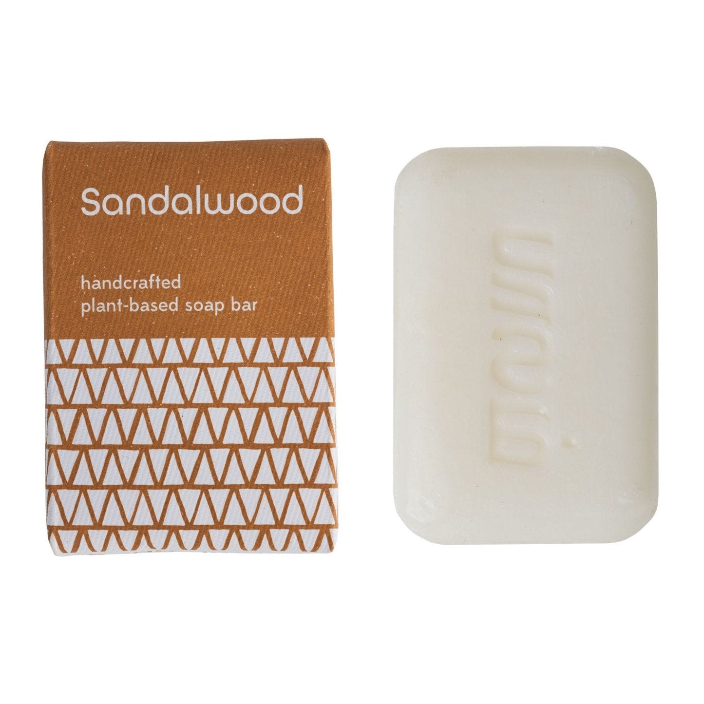 Close-up of handcrafted sandalwood and turmeric soap bar highlighting natural ingredients