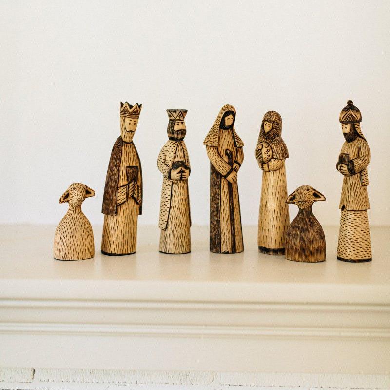 Front view of the handcrafted wooden nativity set featuring detailed Christmas figures.