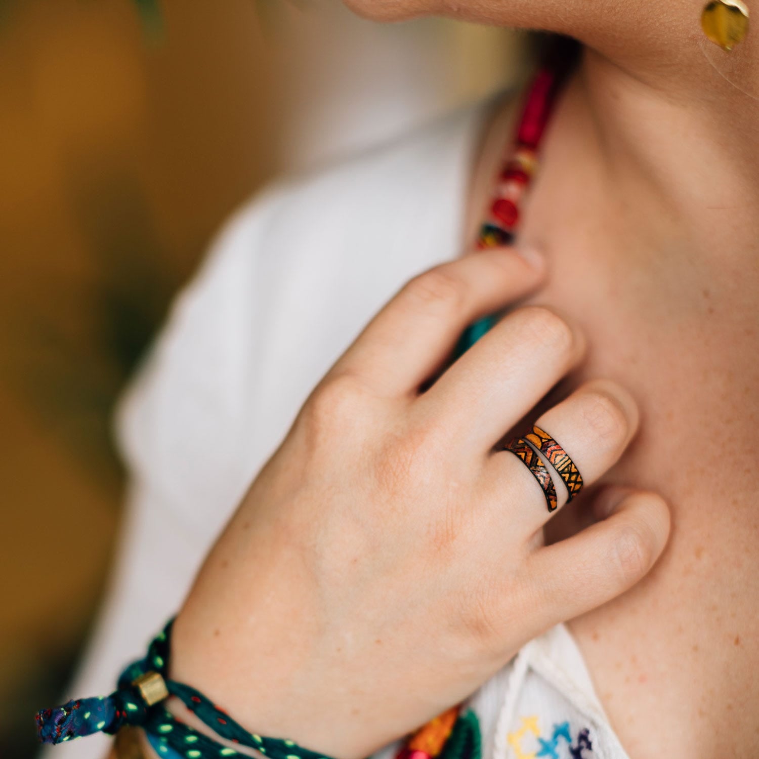 Close-up view of the spiral geometric leather ring highlighting the bright colors and patterns.