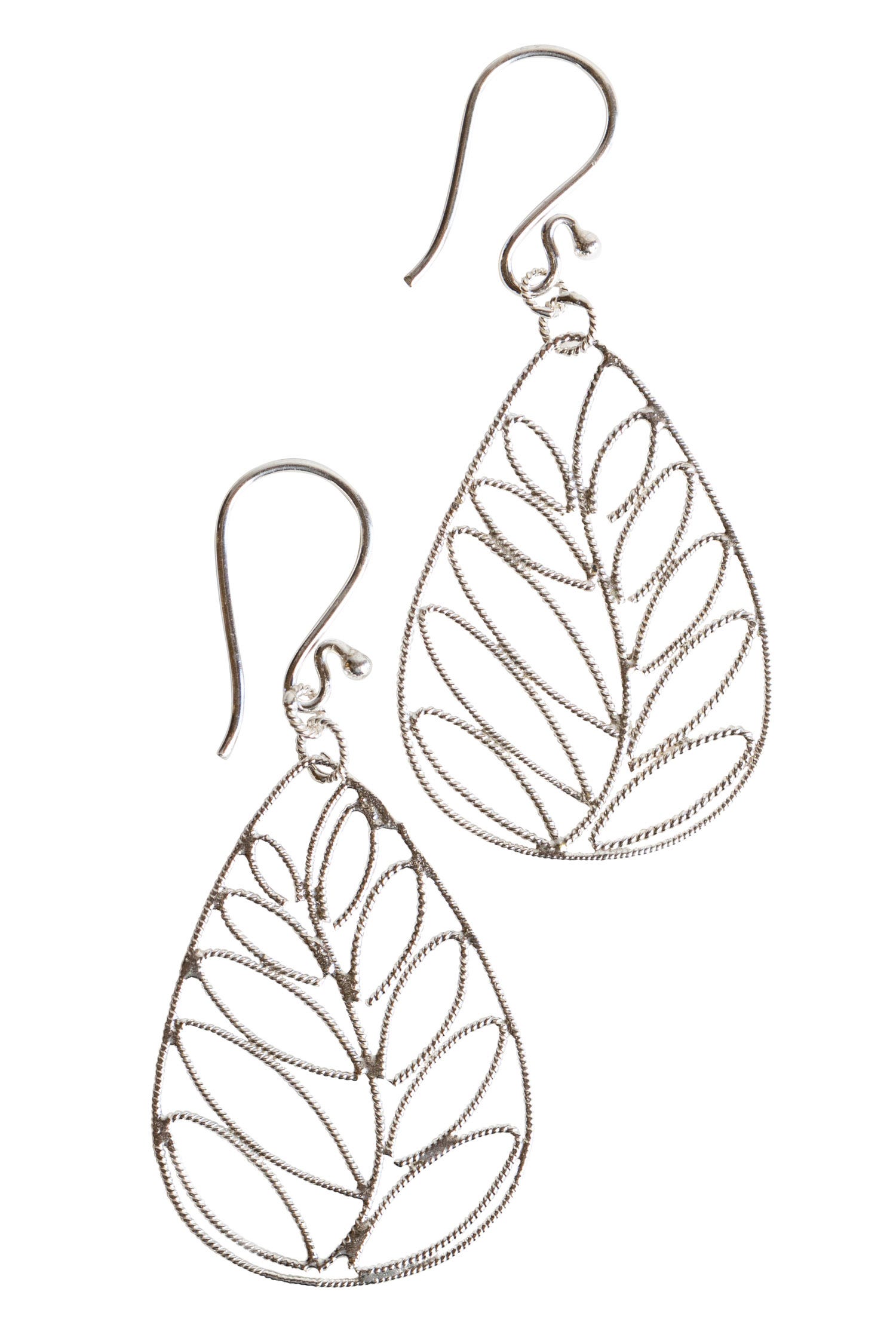 Close-up of handcrafted sterling silver drop earrings with palm leaf design