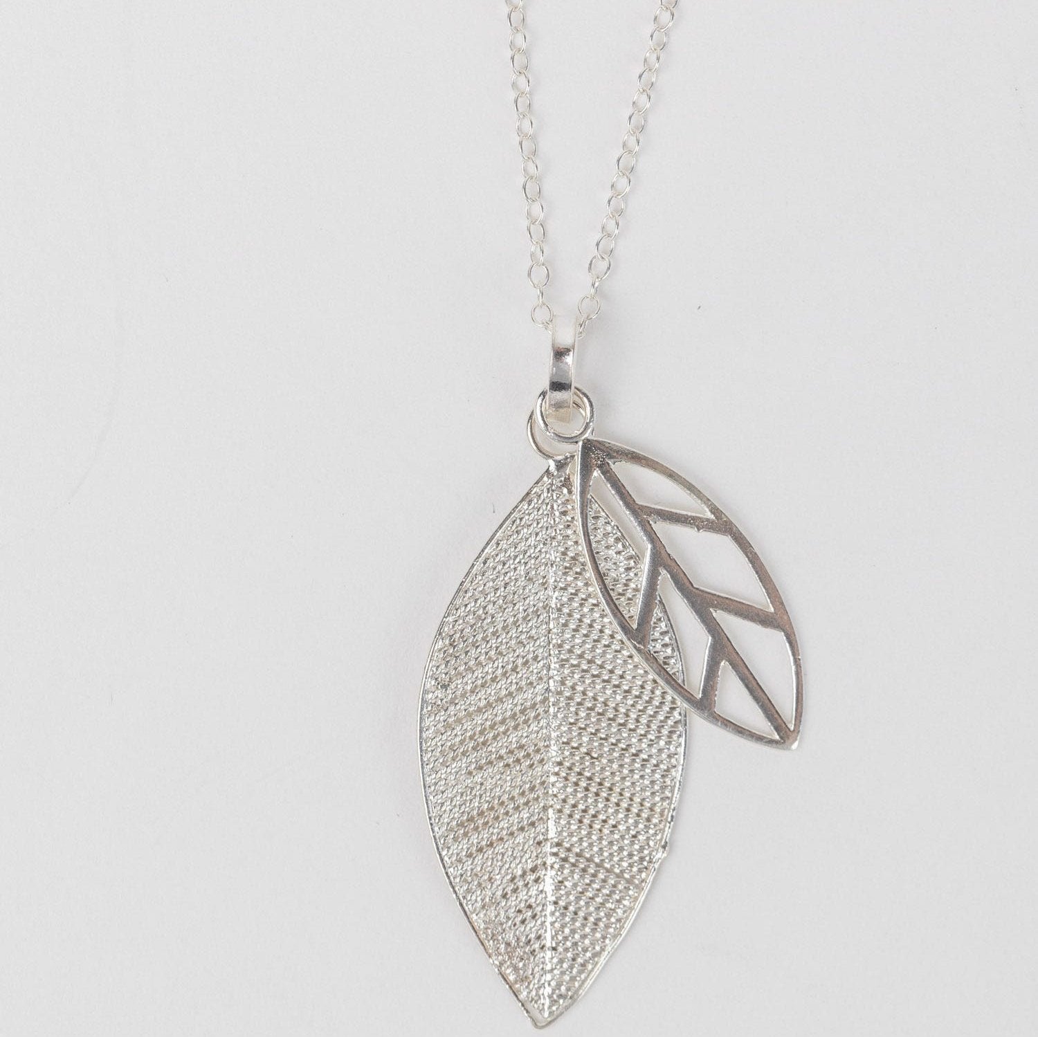 Front view of handcrafted silver leaf necklace with layered design