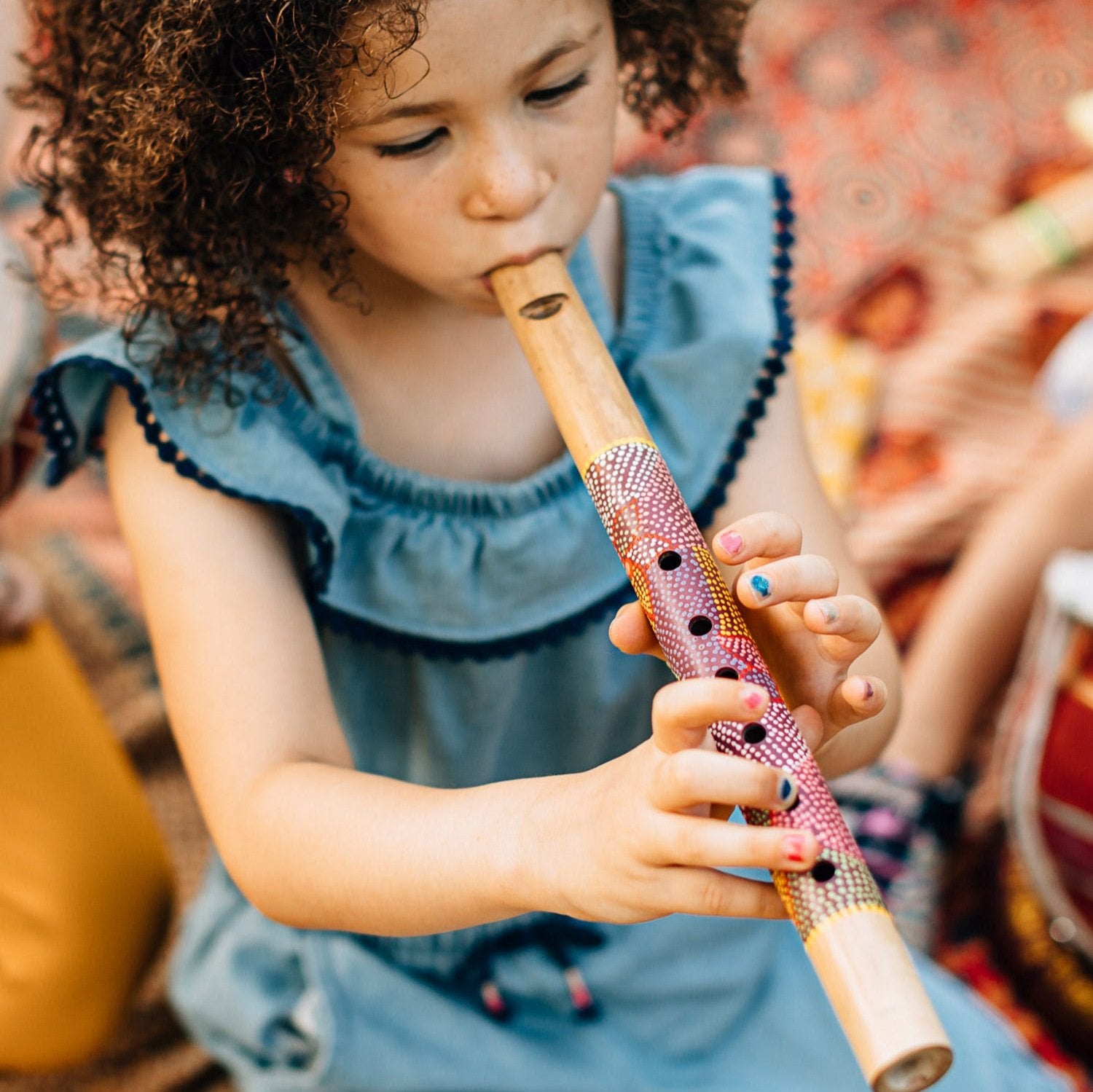 Close-up of hand-painted flower details on Balinese bamboo flute