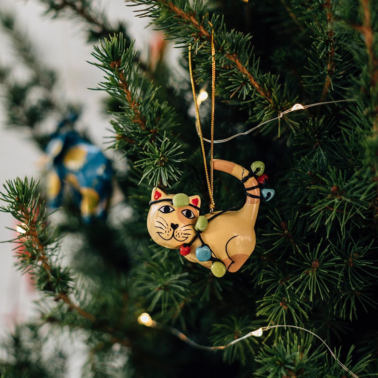 Hand-carved wooden cat ornament displayed on a shelf, showcasing craftsmanship and detail