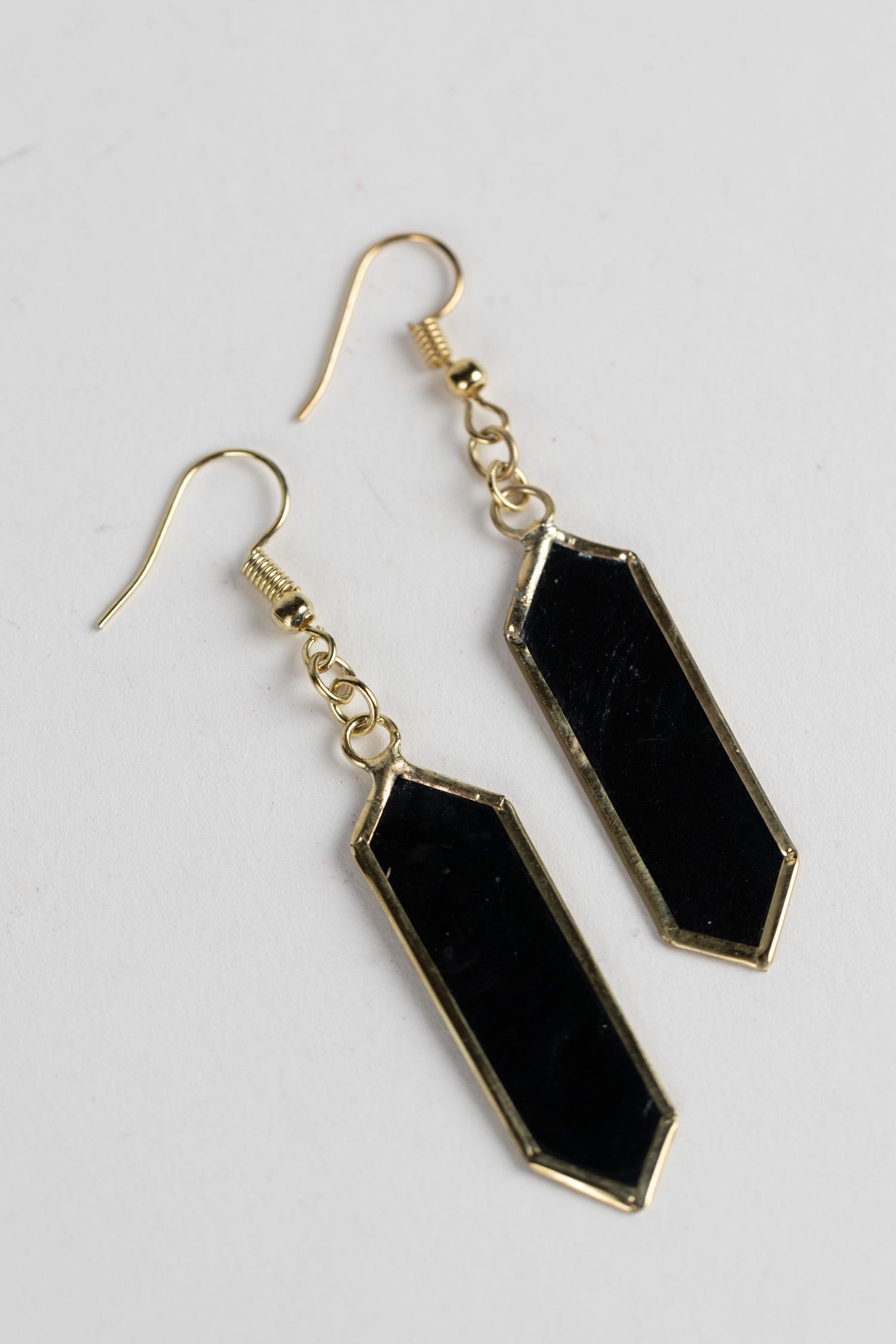 Elegant deep blue dangling earrings showcasing the unique capiz shell craftsmanship.