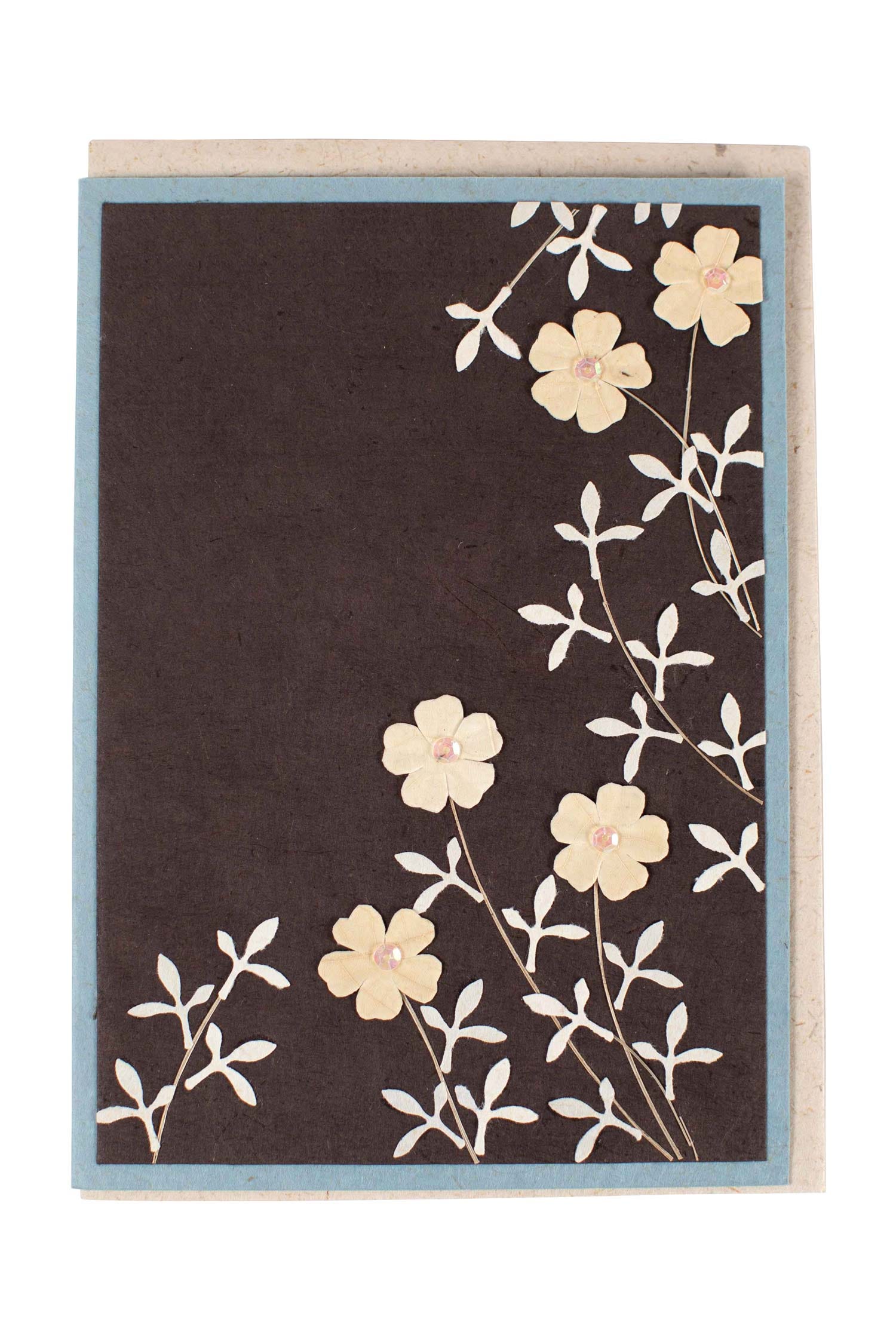 Close-up of a handmade flower greeting card with real leaves embedded in eco-friendly paper