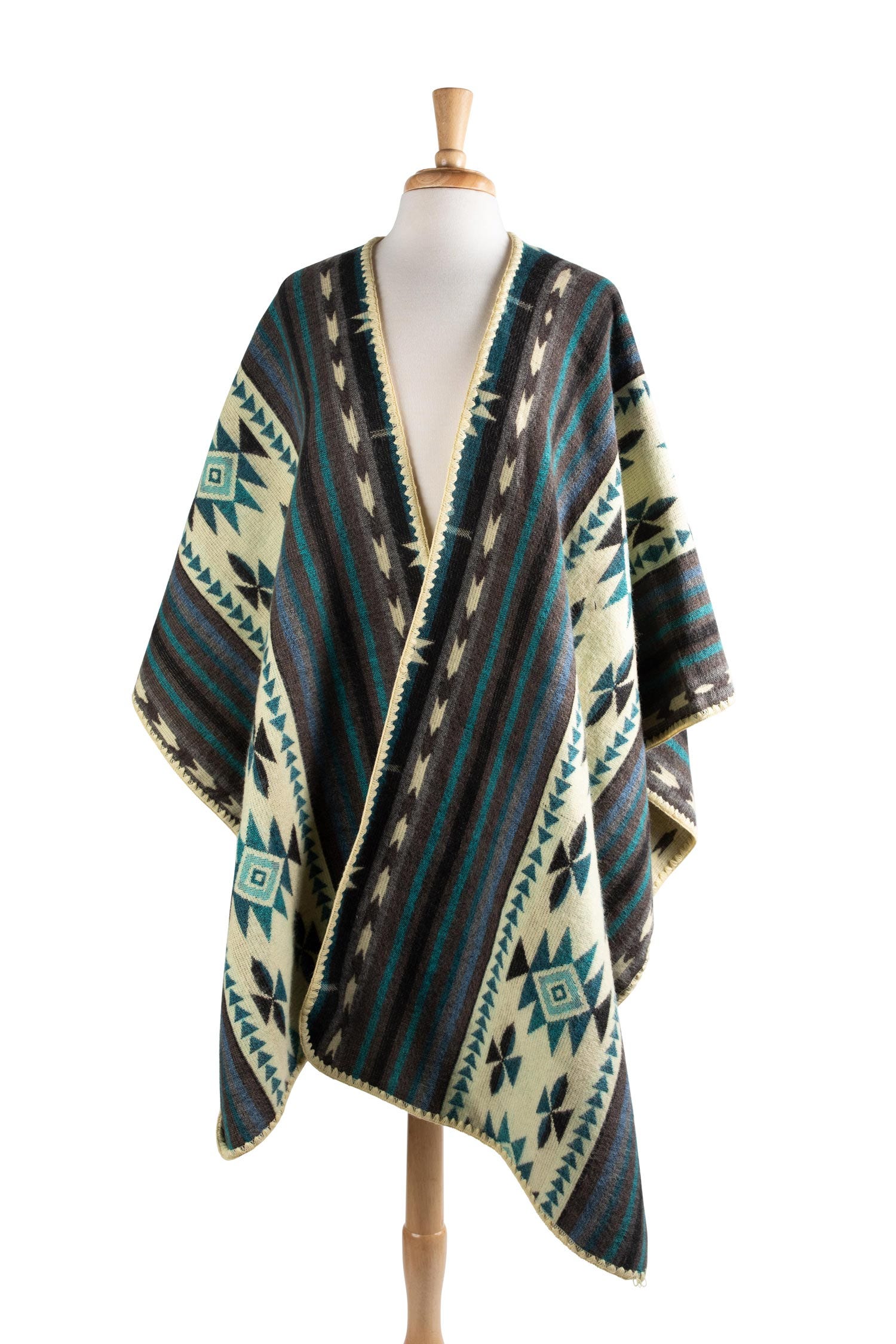 Front view of geometric patterned reversible poncho on model