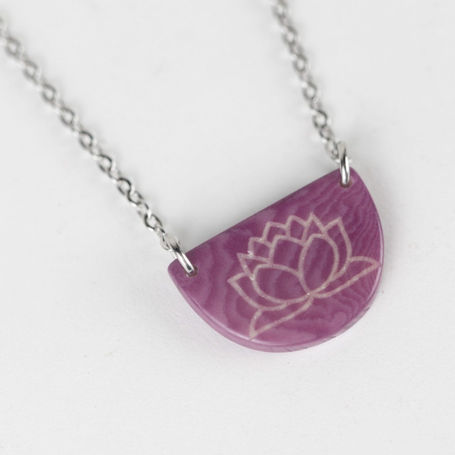 Lotus blossom hope necklace showcasing the tagua charm with a beautiful design emphasizing sustainability.