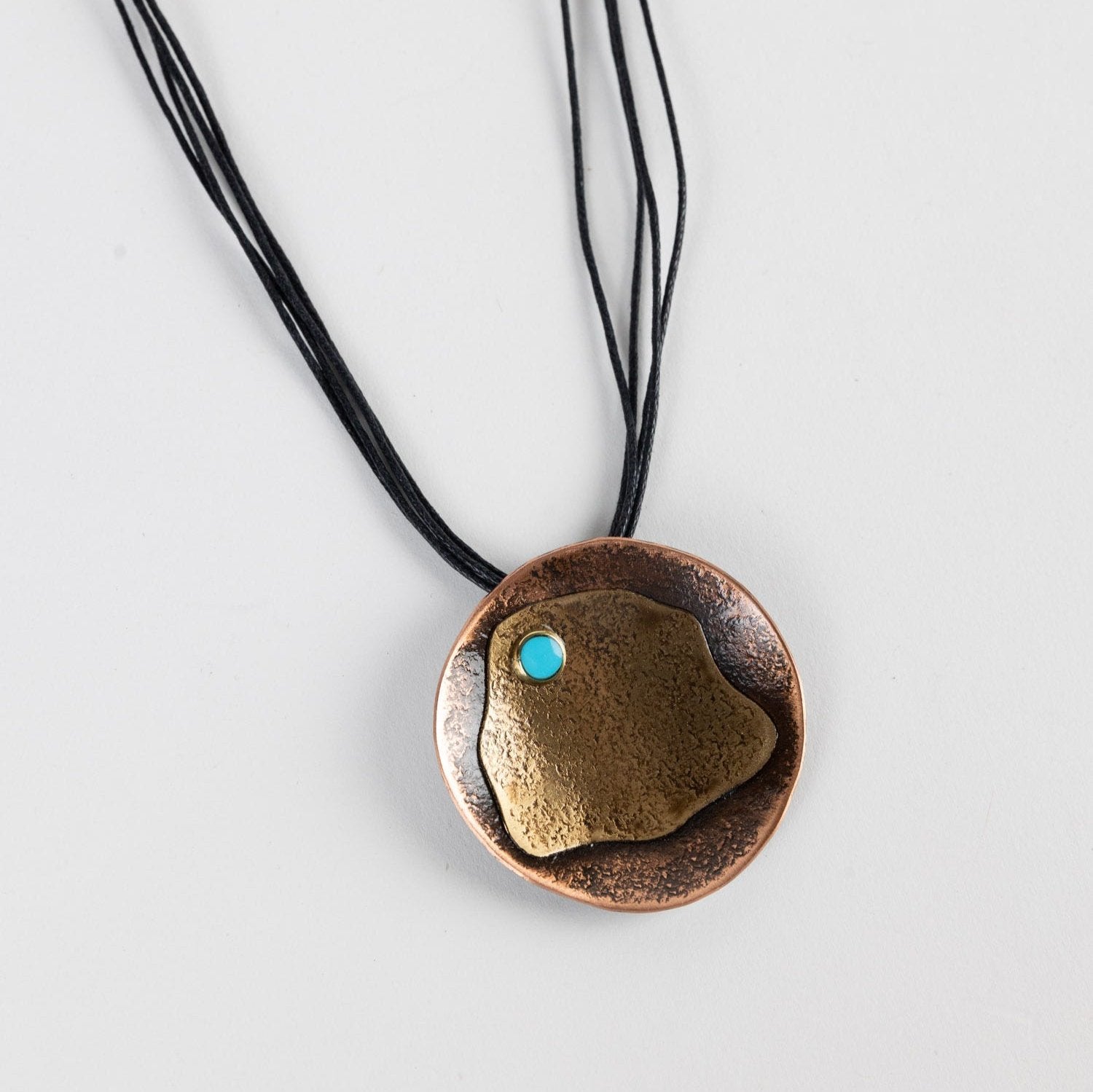 Close-up of hammered copper necklace with adjustable chain for layering