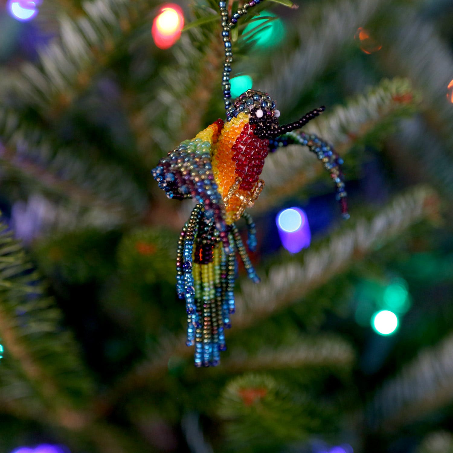 Close-up of vibrant beaded hummingbird ornament, showcasing intricate craftsmanship