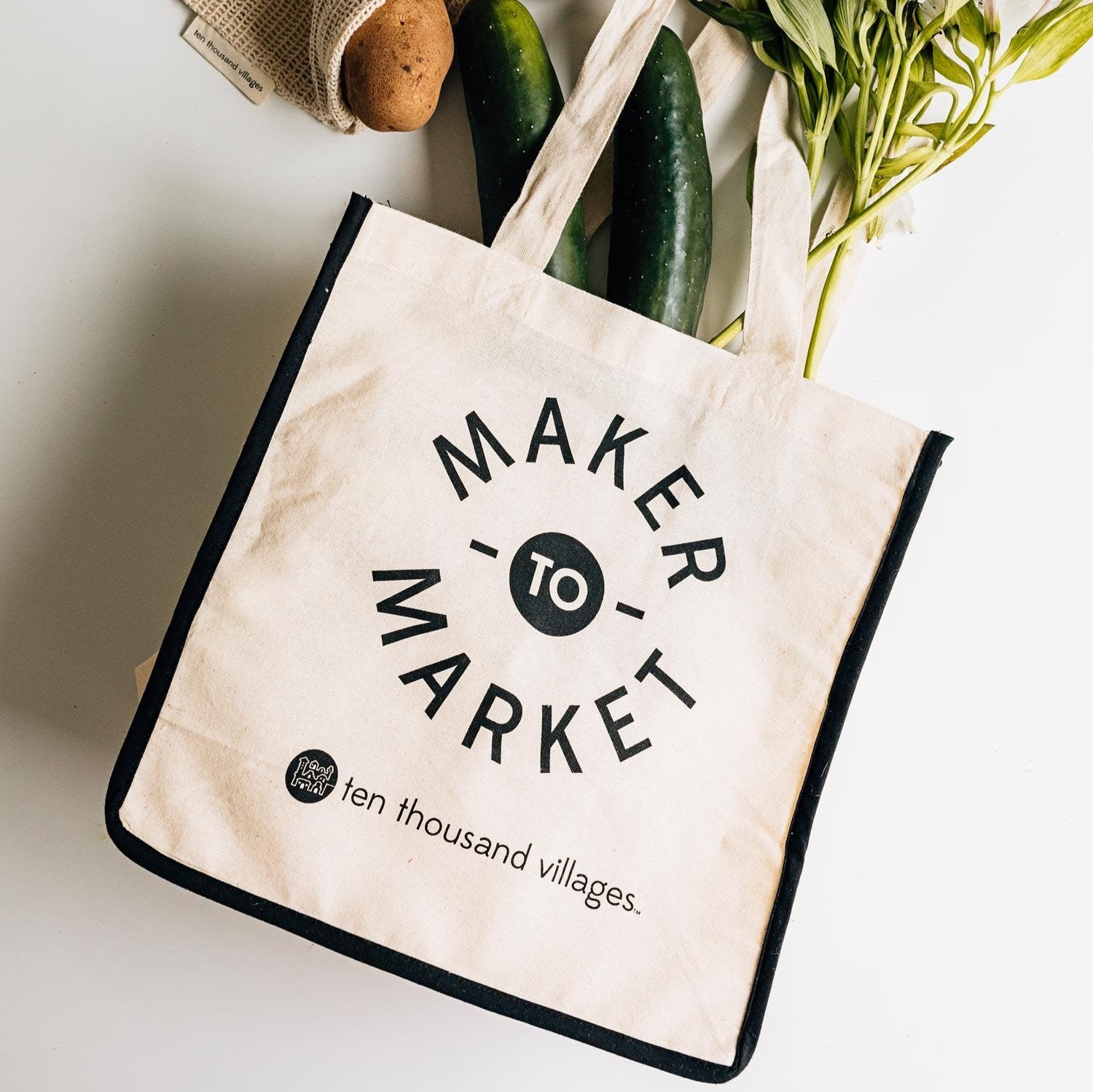 Front view of organic cotton reusable shopping bag on a wooden table