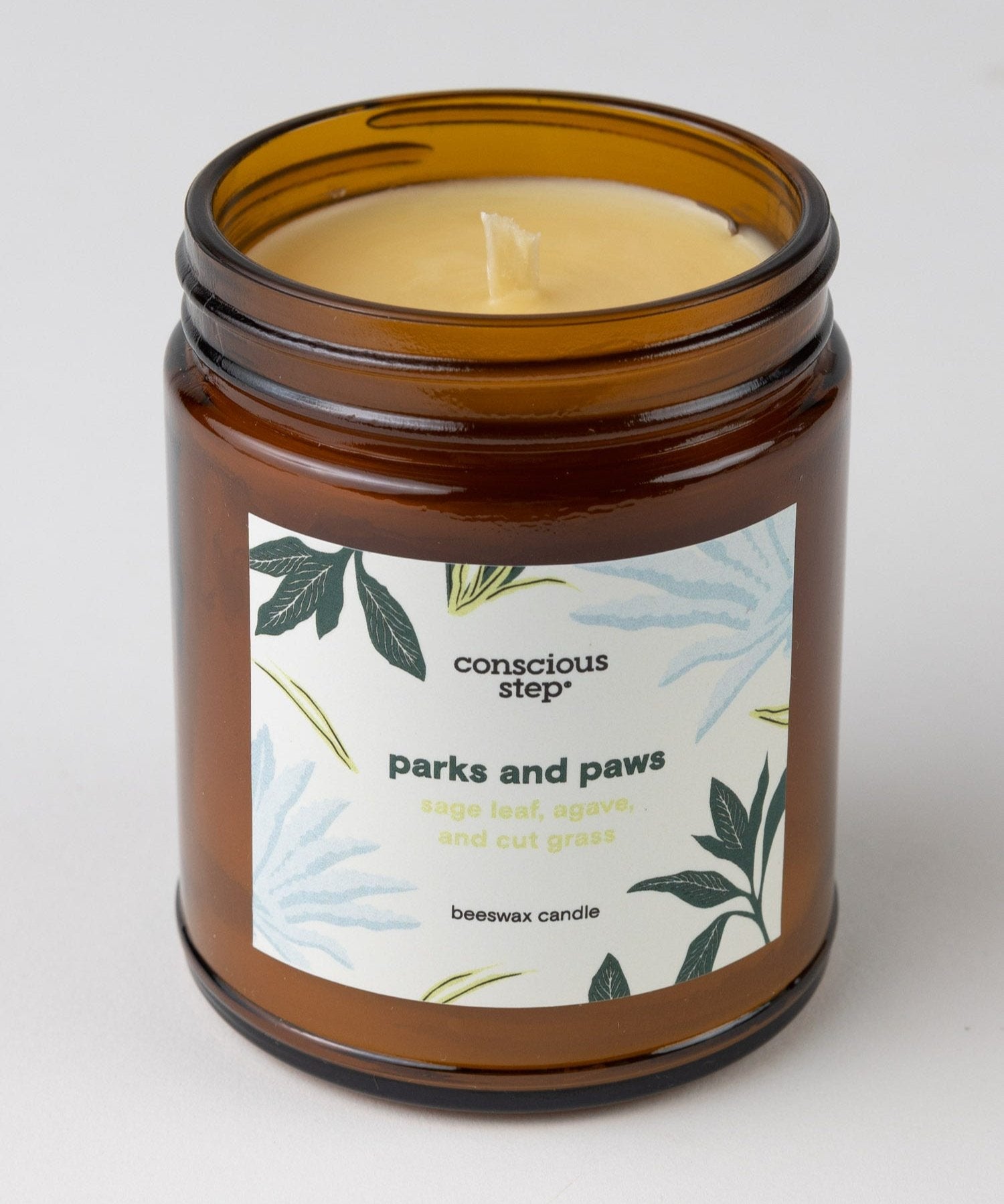 Close-up of Parks and Paws soy candle with herbal scent notes