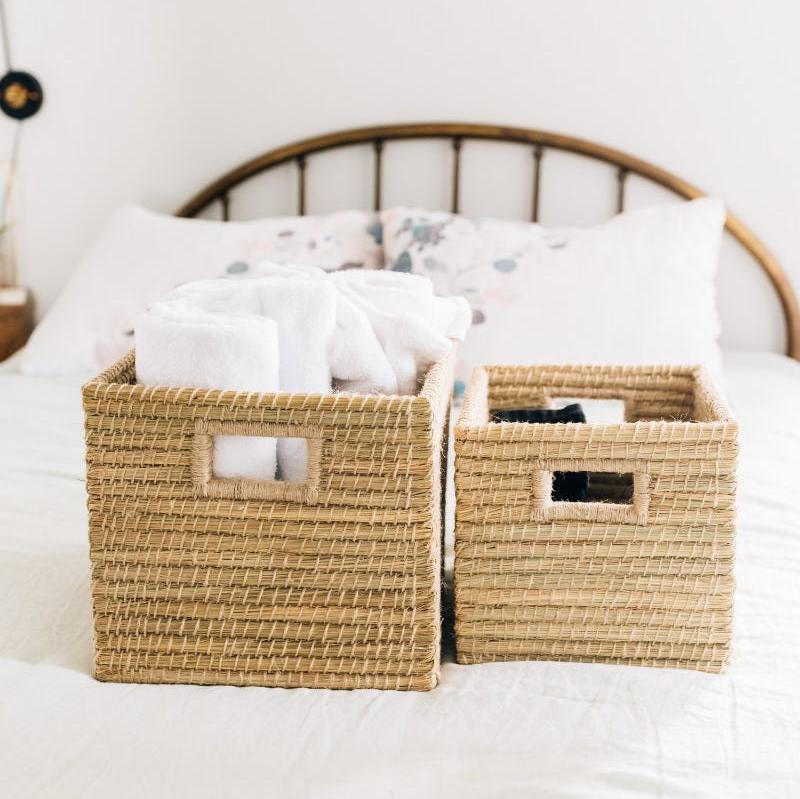 Stylish handwoven basket placed in a cozy living room setting, showcasing its decorative use.