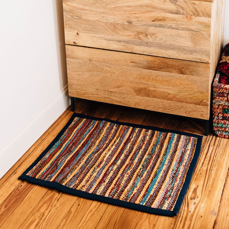 Close-up view of vibrant recycled sari rug showcasing detailed craftsmanship